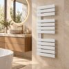 White wall mounted electric towel warmer with LED display in modern minimalist bathroom